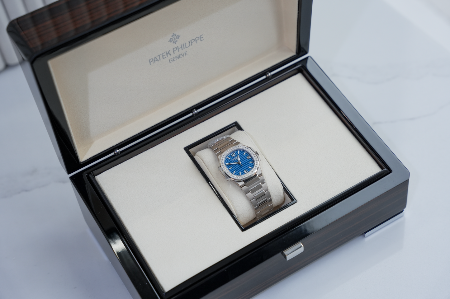 Patek Philippe Nautilus 7010/1G-013 18K White Gold Diamond Bezel Azure Blue Wave Dial 32mm Watch