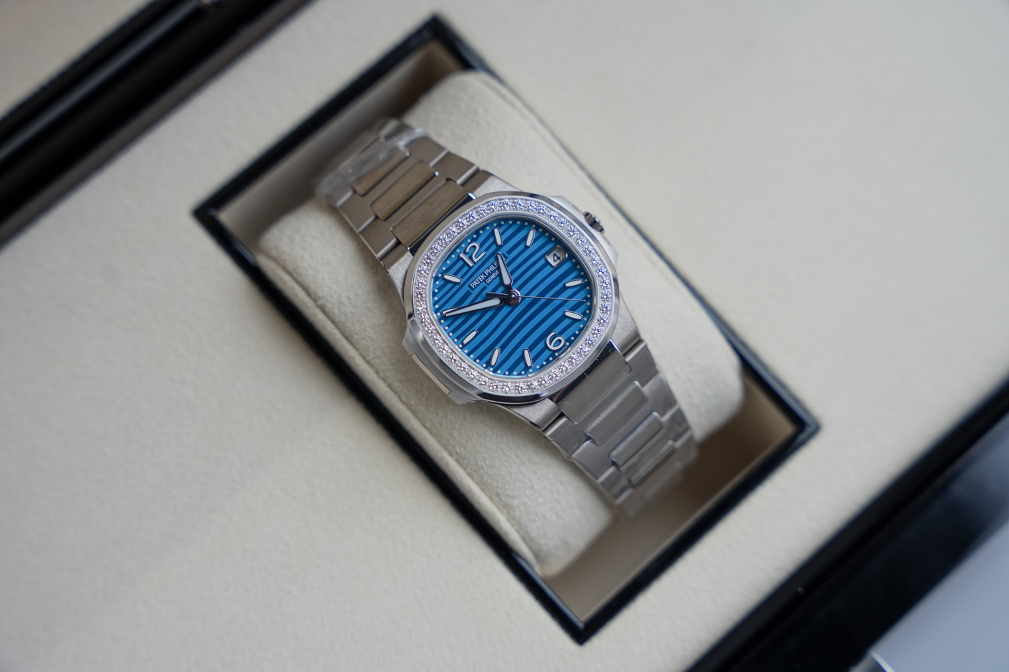 Patek Philippe Nautilus 7010/1G-013 18K White Gold Diamond Bezel Azure Blue Wave Dial 32mm Watch