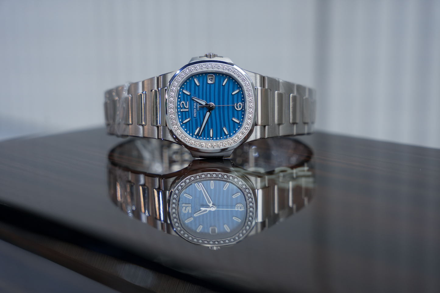 Patek Philippe Nautilus 7010/1G-013 18K White Gold Diamond Bezel Azure Blue Wave Dial 32mm Watch