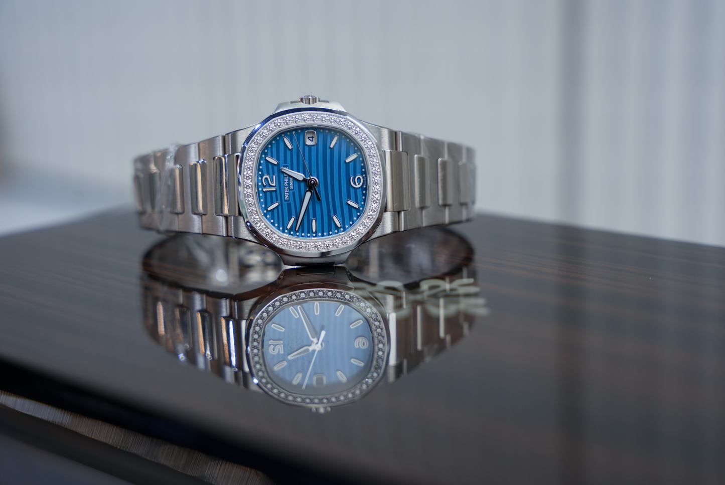 Patek Philippe Nautilus 7010/1G-013 18K White Gold Diamond Bezel Azure Blue Wave Dial 32mm Watch